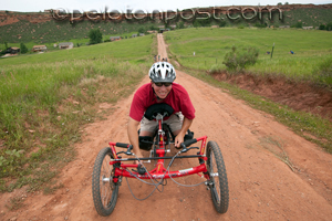 Geoff hand cycling up dirt road